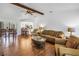 Inviting living room with hardwood floors, a ceiling fan, comfortable seating, and an open layout at 435 Whispering Oaks Ct, Sarasota, FL 34232