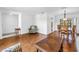 Open-concept living area showcasing hardwood floors and seamless flow into the dining space at 435 Whispering Oaks Ct, Sarasota, FL 34232