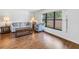 Bright living room showcasing hardwood floors, a large window, and comfortable seating at 435 Whispering Oaks Ct, Sarasota, FL 34232