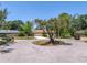 View of the home situated on a quiet cul-de-sac, surrounded by mature trees and landscaping at 435 Whispering Oaks Ct, Sarasota, FL 34232