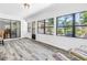 Sunroom offers tranquil views with vinyl floors and access to the outdoor patio at 435 Whispering Oaks Ct, Sarasota, FL 34232