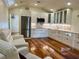 Charming kitchen featuring modern appliances, white cabinetry, and a stylish farmhouse sink at 4412 125Th W St, Cortez, FL 34215