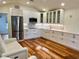 Bright, updated kitchen with white cabinetry, stainless steel appliances, and hardwood floors at 4412 125Th W St, Cortez, FL 34215