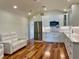 Modern kitchen with white cabinets, stainless steel appliances, and hardwood floors, next to sofa at 4412 125Th W St, Cortez, FL 34215
