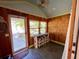 Cozy porch featuring wood paneled walls, counter seating, and a view of the lush outdoors at 4412 125Th W St, Cortez, FL 34215