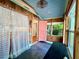 Charming porch featuring painted wood paneled walls, light fixtures, and bead-board ceiling at 4412 125Th W St, Cortez, FL 34215