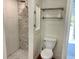 Beautiful shower featuring tile walls and floors, complemented by modern fixtures and shelving at 4412 125Th W St, Cortez, FL 34215
