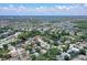 This aerial shot features a well-established residential area with a mix of housing styles and water views in the background at 4603 4Th E Ave, Bradenton, FL 34208