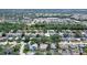 Aerial view showcases a suburban community with mature trees, nearby shopping centers, and easy access to daily conveniences at 4603 4Th E Ave, Bradenton, FL 34208