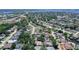 An aerial view shows a community with tree-lined streets, single-Gathering homes, and access to the Manatee River in the distance at 4603 4Th E Ave, Bradenton, FL 34208