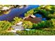 Waterfront property with private dock, surrounded by lush greenery, kayaks, and serene water views at 4603 4Th E Ave, Bradenton, FL 34208