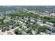 An aerial view highlights a residential neighborhood with tree cover, green spaces, and proximity to local amenities at 4603 4Th E Ave, Bradenton, FL 34208