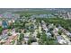 An aerial view shows a community with nearby lakes and waterways, a mix of housing, and lots of mature trees at 4603 4Th E Ave, Bradenton, FL 34208