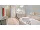 Bright bathroom with a soaking tub, walk-in shower and stylish decor at 4603 4Th E Ave, Bradenton, FL 34208