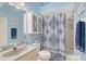 Inviting blue-themed bathroom featuring a shower-tub combo and ample cabinet storage at 4603 4Th E Ave, Bradenton, FL 34208
