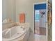 Bathroom with a soaking tub and a doorway that leads to another room at 4603 4Th E Ave, Bradenton, FL 34208