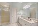 Bright bathroom with a large mirror, double sink vanity, and walk-in shower at 4603 4Th E Ave, Bradenton, FL 34208