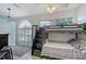Charming bedroom with a bunkbed, stylish rug, and a ceiling fan at 4603 4Th E Ave, Bradenton, FL 34208