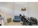 Bright bedroom featuring a cozy blue sofa and a work desk at 4603 4Th E Ave, Bradenton, FL 34208