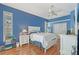 Bright blue bedroom with a ceiling fan and lots of natural light at 4603 4Th E Ave, Bradenton, FL 34208