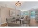 A dining room featuring a glass table and seating with modern light fixtures at 4603 4Th E Ave, Bradenton, FL 34208