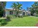The charming two-story home has a well-manicured lawn and mature trees in the front yard at 4603 4Th E Ave, Bradenton, FL 34208