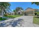 Lovely single-story home featuring a porte-cochère, well-kept lawn, and lush greenery at 4603 4Th E Ave, Bradenton, FL 34208