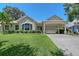 Charming single-story home with a well-manicured lawn, porte-cochère and lush landscaping at 4603 4Th E Ave, Bradenton, FL 34208