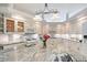 Bright and airy kitchen featuring granite countertops, white cabinetry, and modern lighting at 4603 4Th E Ave, Bradenton, FL 34208