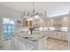 Bright kitchen with white cabinets, granite countertops, and a central island at 4603 4Th E Ave, Bradenton, FL 34208