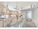 Spacious kitchen featuring a large island with seating, white cabinets, and modern appliances at 4603 4Th E Ave, Bradenton, FL 34208