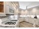 Well-lit kitchen with white cabinets, stainless steel appliances, and stylish backsplash at 4603 4Th E Ave, Bradenton, FL 34208