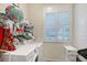 Laundry room with washer, dryer, wire shelving, storage, and plantation shutters at 4603 4Th E Ave, Bradenton, FL 34208