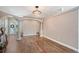 Open-concept living space with hardwood floors, arched doorways, and a modern light fixture at 4603 4Th E Ave, Bradenton, FL 34208