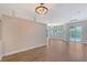 A spacious, light-filled room with hardwood floors and a contemporary light fixture at 4603 4Th E Ave, Bradenton, FL 34208