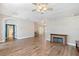 Open living space with hardwood floors, arched doorways, and a modern fireplace at 4603 4Th E Ave, Bradenton, FL 34208