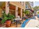 Charming outdoor patio with tables, chairs, and lush plants, perfect for dining and relaxation at 4603 4Th E Ave, Bradenton, FL 34208