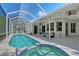 Screened outdoor patio featuring a pool, hot tub, and covered seating area at 4603 4Th E Ave, Bradenton, FL 34208