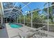 A screened in pool with lounge chairs on the deck provides an ideal relaxation space at 4603 4Th E Ave, Bradenton, FL 34208