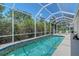 Screened-in pool area with beautiful greenery surrounding the enclosure, creating a private outdoor oasis at 4603 4Th E Ave, Bradenton, FL 34208