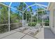 A screened in lanai with lounge chairs offer a relaxing retreat poolside at 4603 4Th E Ave, Bradenton, FL 34208
