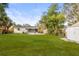 Spacious backyard featuring a well-maintained lawn and a screened-in lanai at 5045 10Th S Ave, Gulfport, FL 33707