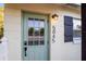 Close-up view of the front door with a modern security keypad and an inviting light fixture at 5045 10Th S Ave, Gulfport, FL 33707