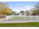 Quaint home with a white picket fence and lush green lawn at 5045 10Th S Ave, Gulfport, FL 33707