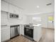 Modern kitchen featuring stainless steel appliances, an island, and bright, white cabinets at 5045 10Th S Ave, Gulfport, FL 33707