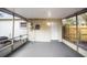Covered porch with white walls and door access to the backyard and an exterior access door at 5045 10Th S Ave, Gulfport, FL 33707