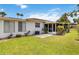 Landscaped backyard featuring well-maintained lawn, patio area, and tropical foliage at 5062 White Oak Ct, Bradenton, FL 34207