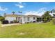 Expansive backyard featuring a patio, green lawn, and mature landscaping at 5062 White Oak Ct, Bradenton, FL 34207