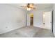 A well-lit bedroom with a ceiling fan, carpet, and access to the bathroom at 5062 White Oak Ct, Bradenton, FL 34207