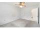 A carpeted bedroom with a ceiling fan, ample natural light, and easy bathroom access at 5062 White Oak Ct, Bradenton, FL 34207